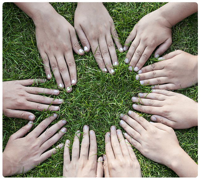 A group of hands are arranged in the shape of a circle.