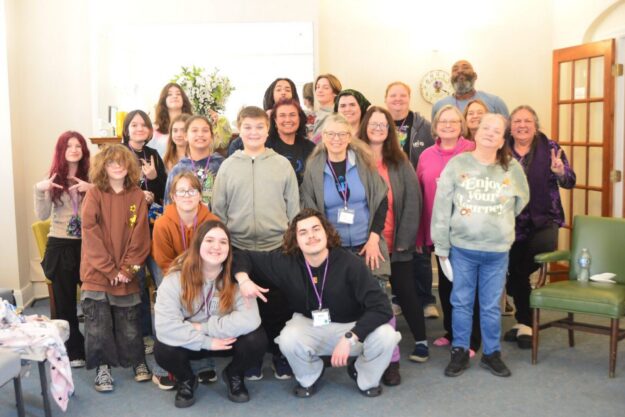 Group photo of smiling individuals together.